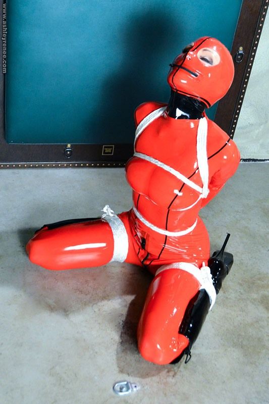 Ashley Renee in red latex catsuit & ballet shoes tied up on floo